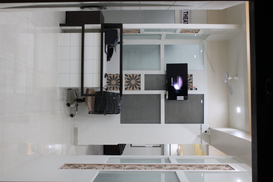 Aerial perspective of the Insight Institute operation theatre lobby with concierge desk, endoscope monitor and laser-cut floral feature wall
